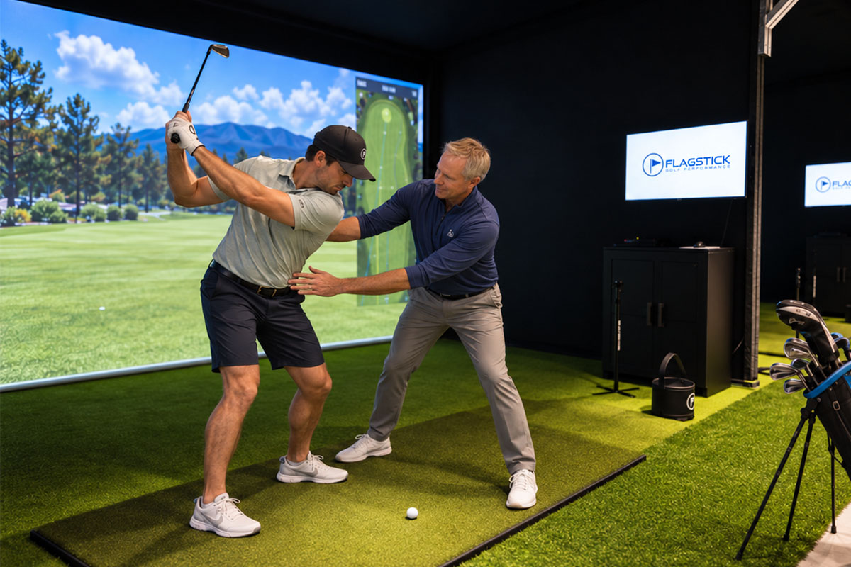 Phil Truono helping a golfer improve body position during a lesson at Flagstick
